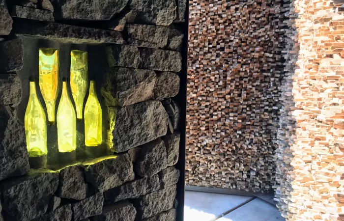 a wall with bright bottles