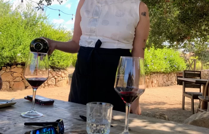 a waitress serving wine