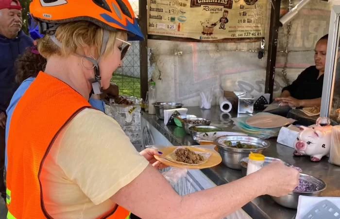 Lady preparing a taco