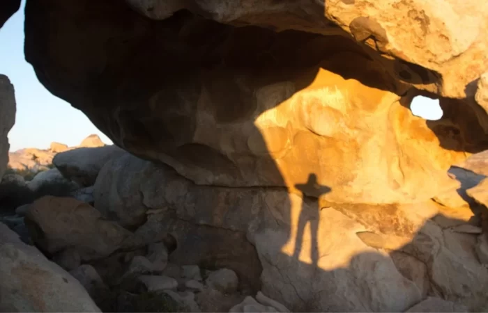 a shadow among boulders