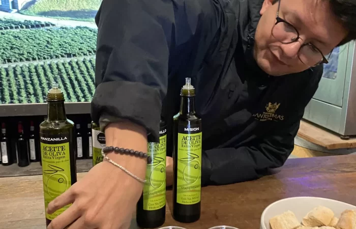 a man serving olive oil