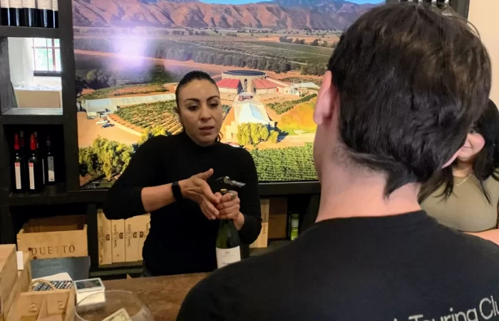 a woman serving wine