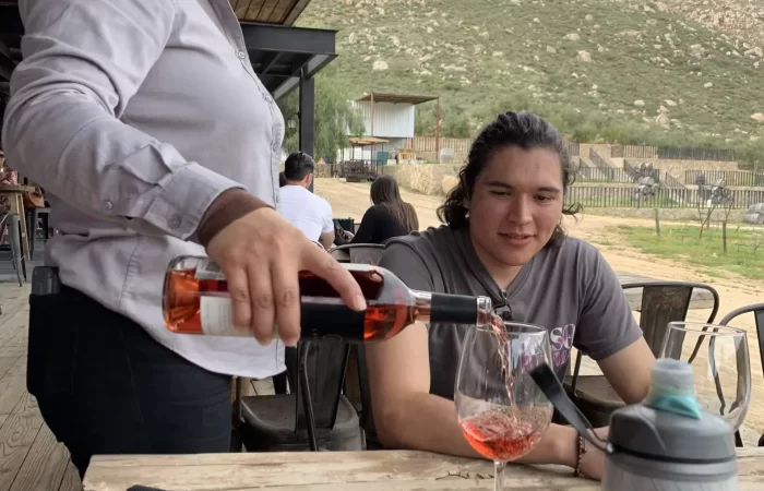 a woman serving wine