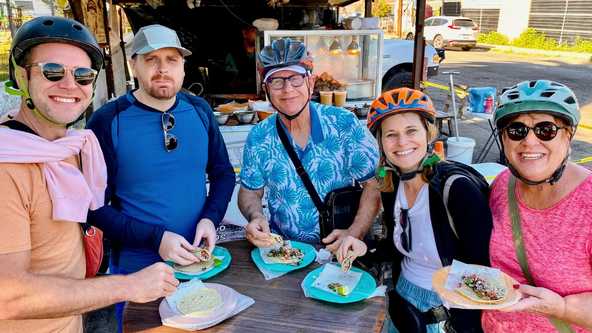 Participants enjoying the Tacos and Bike day tour in Ensenada, cycling to local food spots with MexGeo Tours